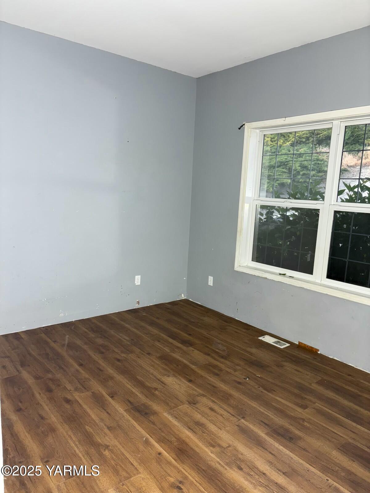 359 Riggins Road Wapato, WA 98951 - Photo 16 of 16 a view of an empty room with wooden floor and a window