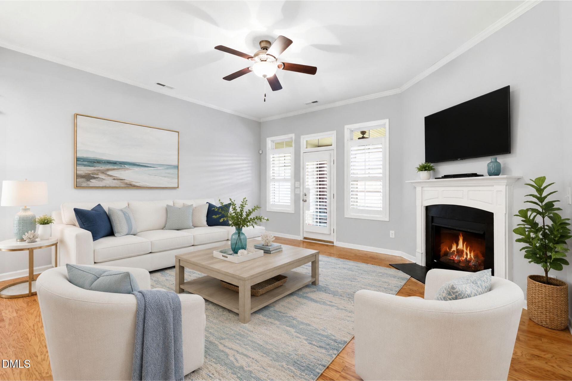 522 Brunello Drive Wake Forest, NC 27587 - Photo 7 of 24 a living room with furniture a fireplace and a flat screen tv