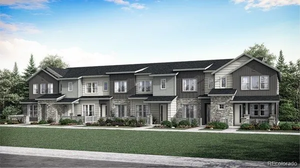 a front view of residential houses with yard and green space