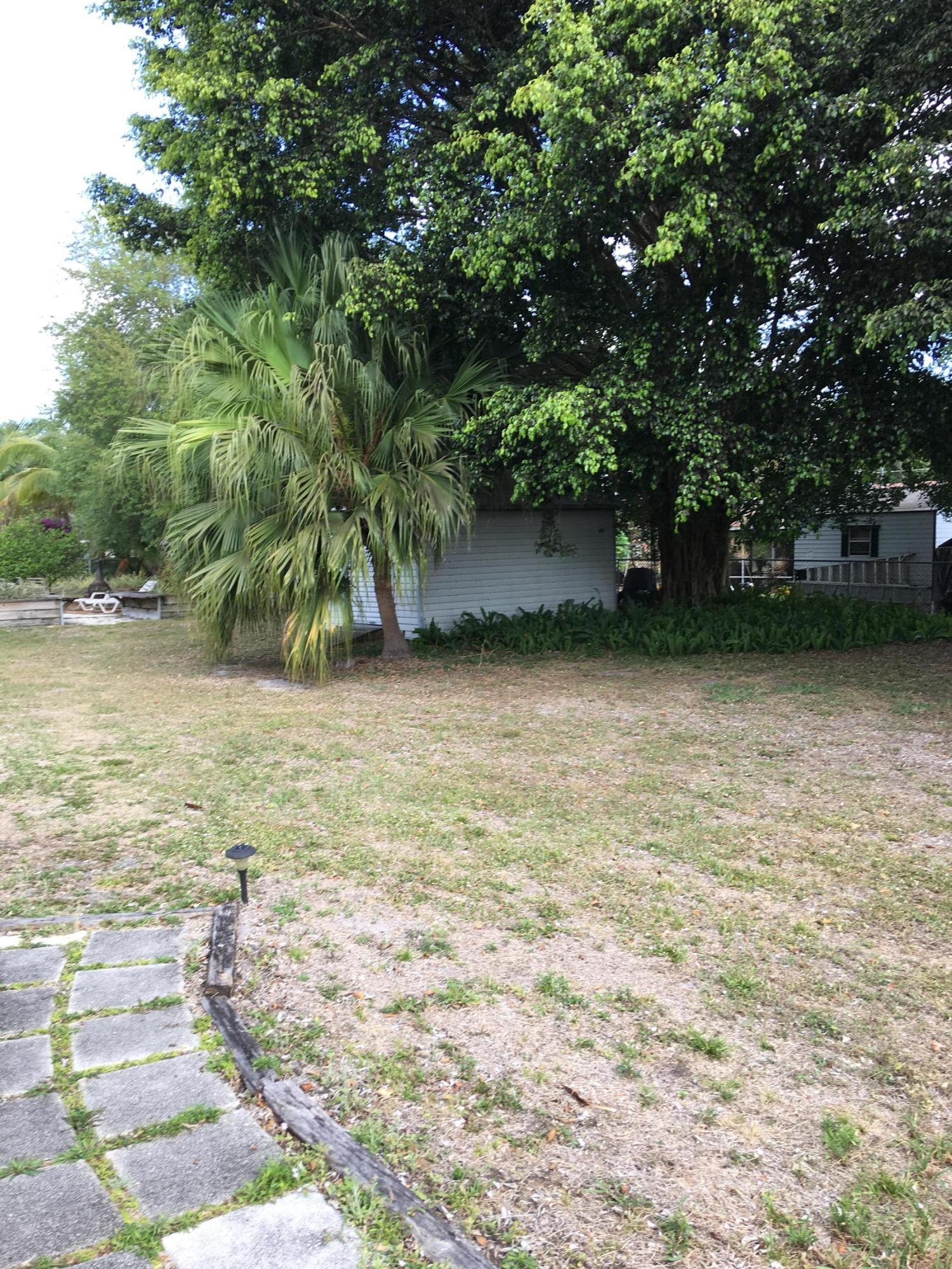 279 Southwest Homeland Road Port St. Lucie, FL 34953 - Photo 9 of 11 HOMELAND back with shed