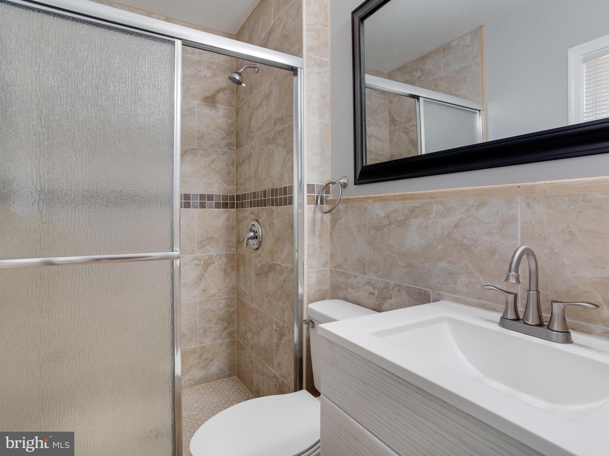 6006 Queens Chapel Road Hyattsville, MD 20782 - Photo 11 of 19 a bathroom with a sink toilet and shower