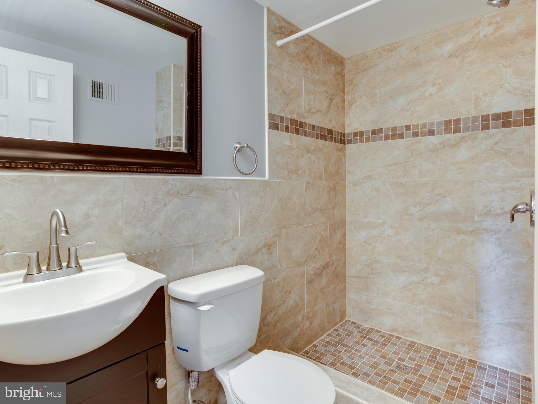 6006 Queens Chapel Road Hyattsville, MD 20782 - Photo 15 of 19 a bathroom with a sink toilet and shower