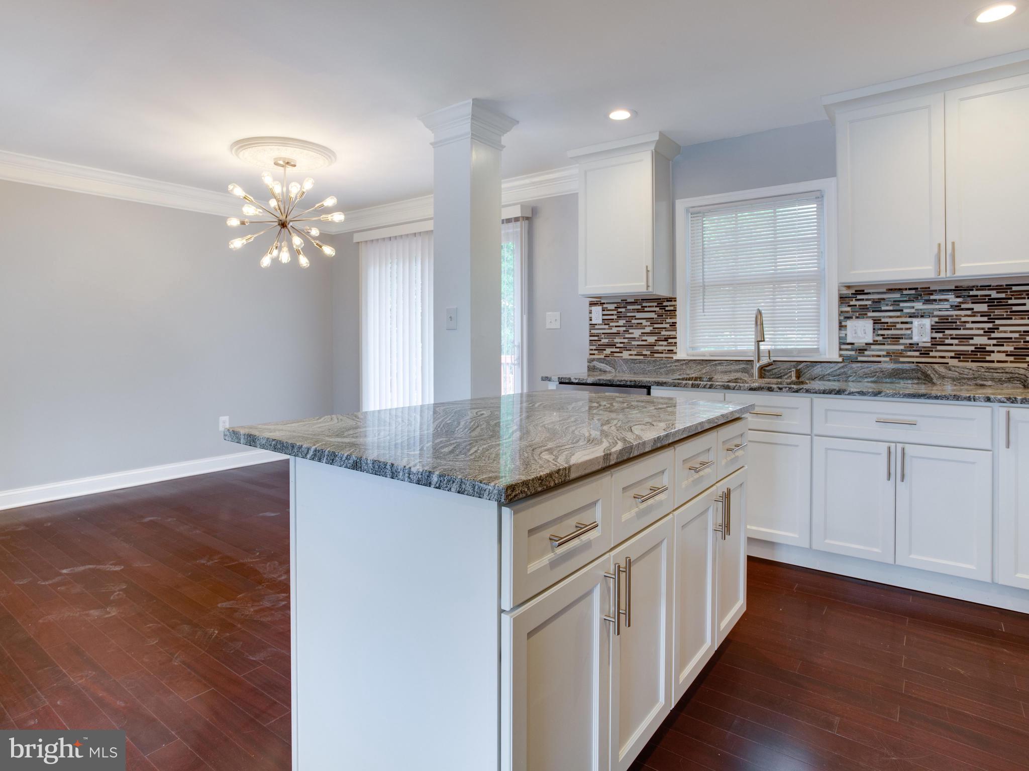 6006 Queens Chapel Road Hyattsville, MD 20782 - Photo 5 of 19 a kitchen with stainless steel appliances granite countertop a sink cabinets and wooden floor