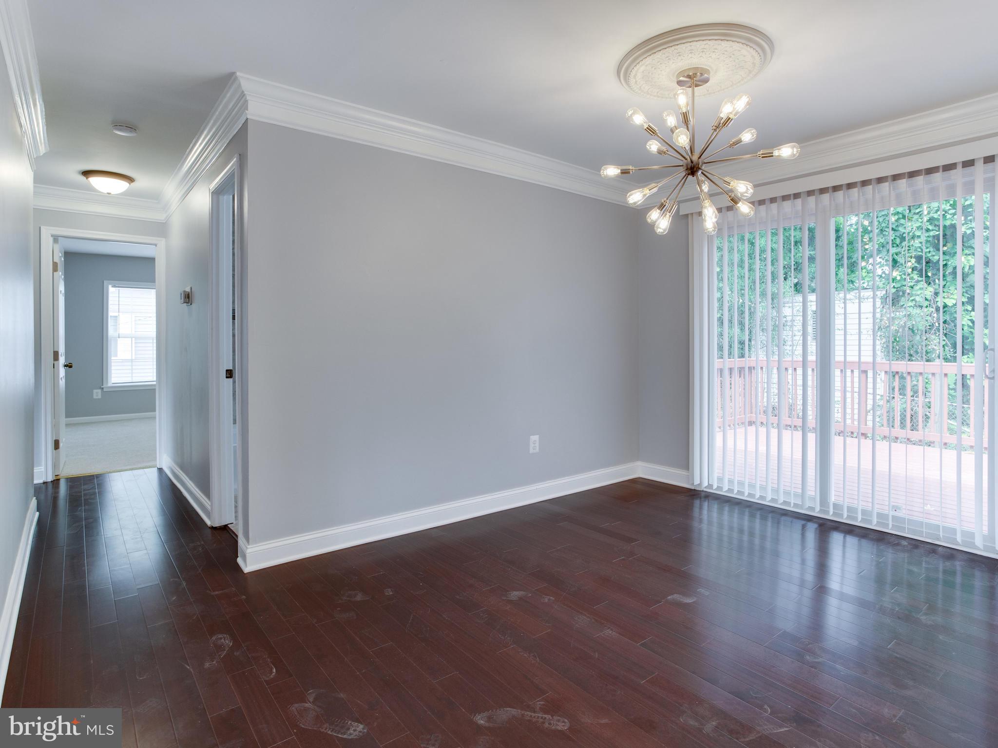 6006 Queens Chapel Road Hyattsville, MD 20782 - Photo 7 of 19 an empty room with wooden floor and windows