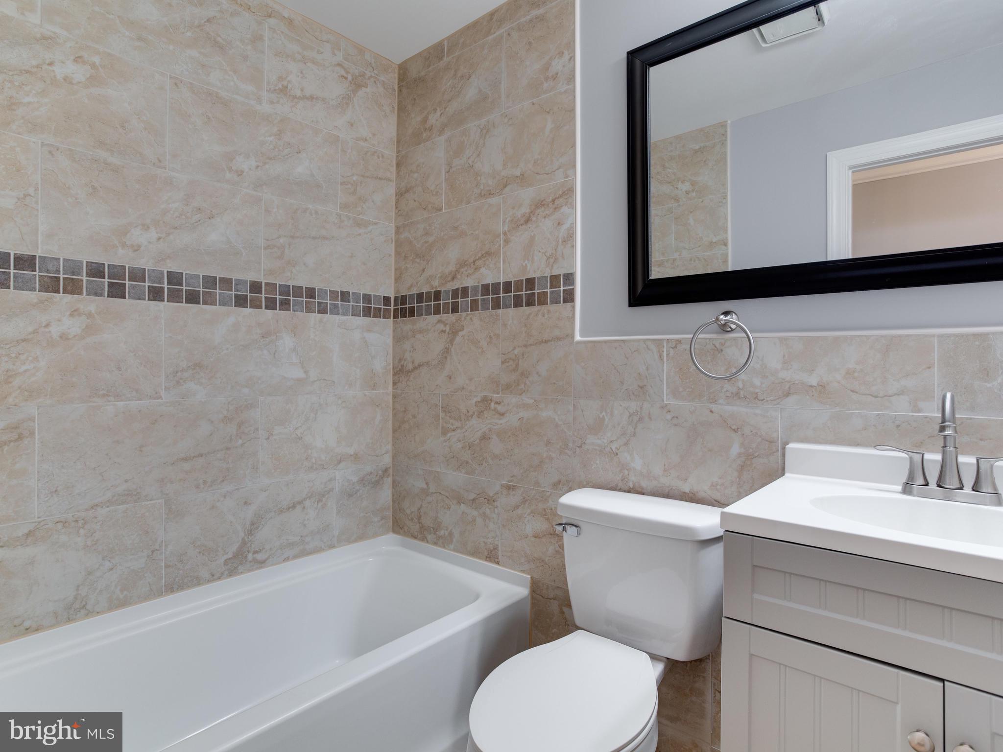 6006 Queens Chapel Road Hyattsville, MD 20782 - Photo 8 of 19 a bathroom with a toilet a sink and bathtub