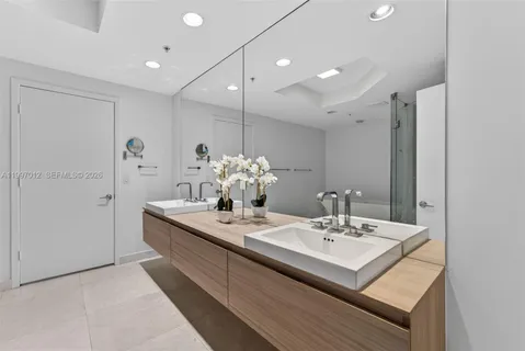 a bathroom with a sink a mirror and a shower