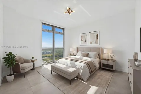 a spacious bedroom with a bed and a couch