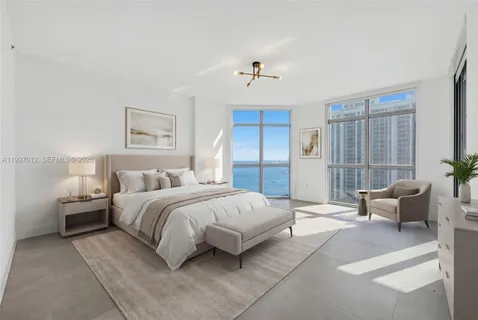 a spacious bedroom with a bed and a chandelier