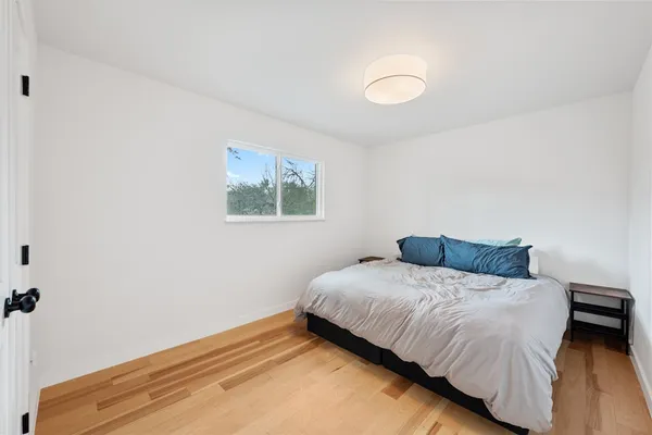 a bedroom with a bed and a night stand