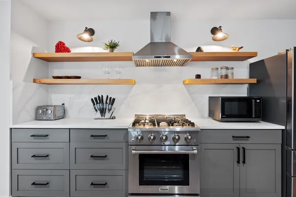 a kitchen with a stove and cabinets