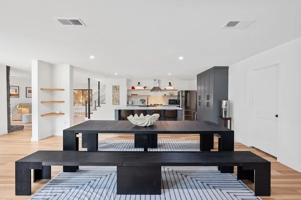a kitchen with stainless steel appliances granite countertop a refrigerator and a stove top oven