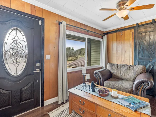 a living room with furniture a table and a large window