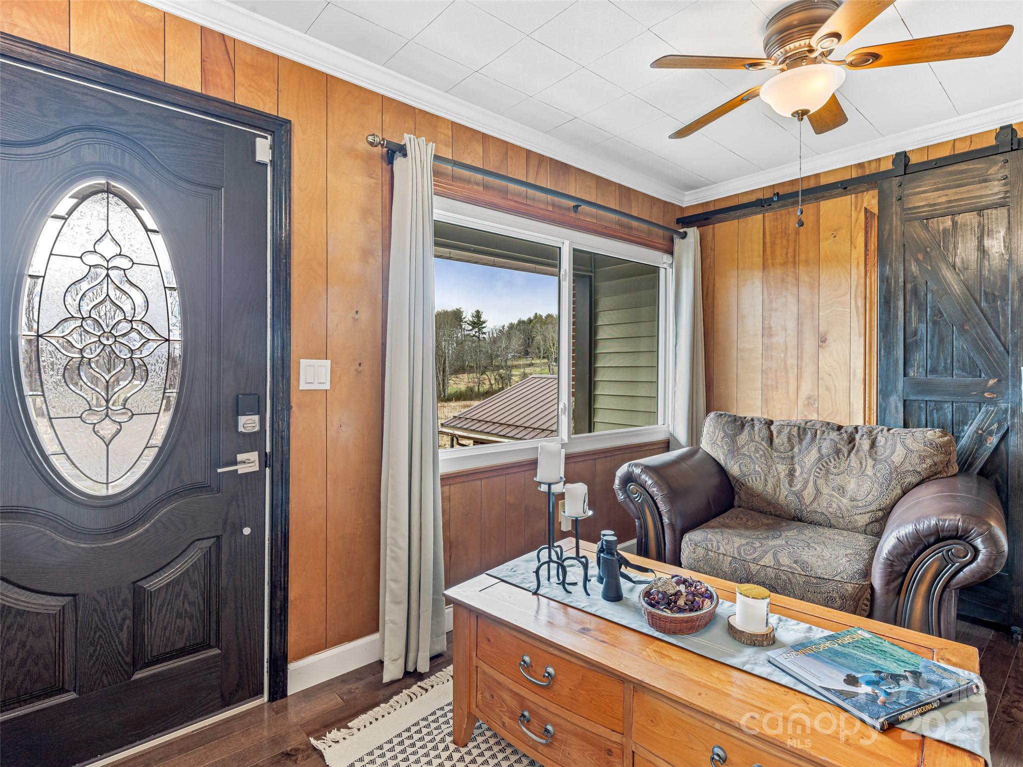 372 Hamilton Road Penrose, NC 28766 - Photo 12 of 38 a living room with furniture a table and a large window