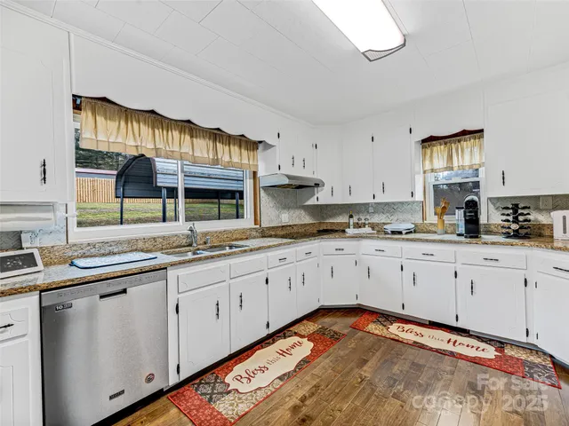 a kitchen with stainless steel appliances granite countertop a sink and cabinets