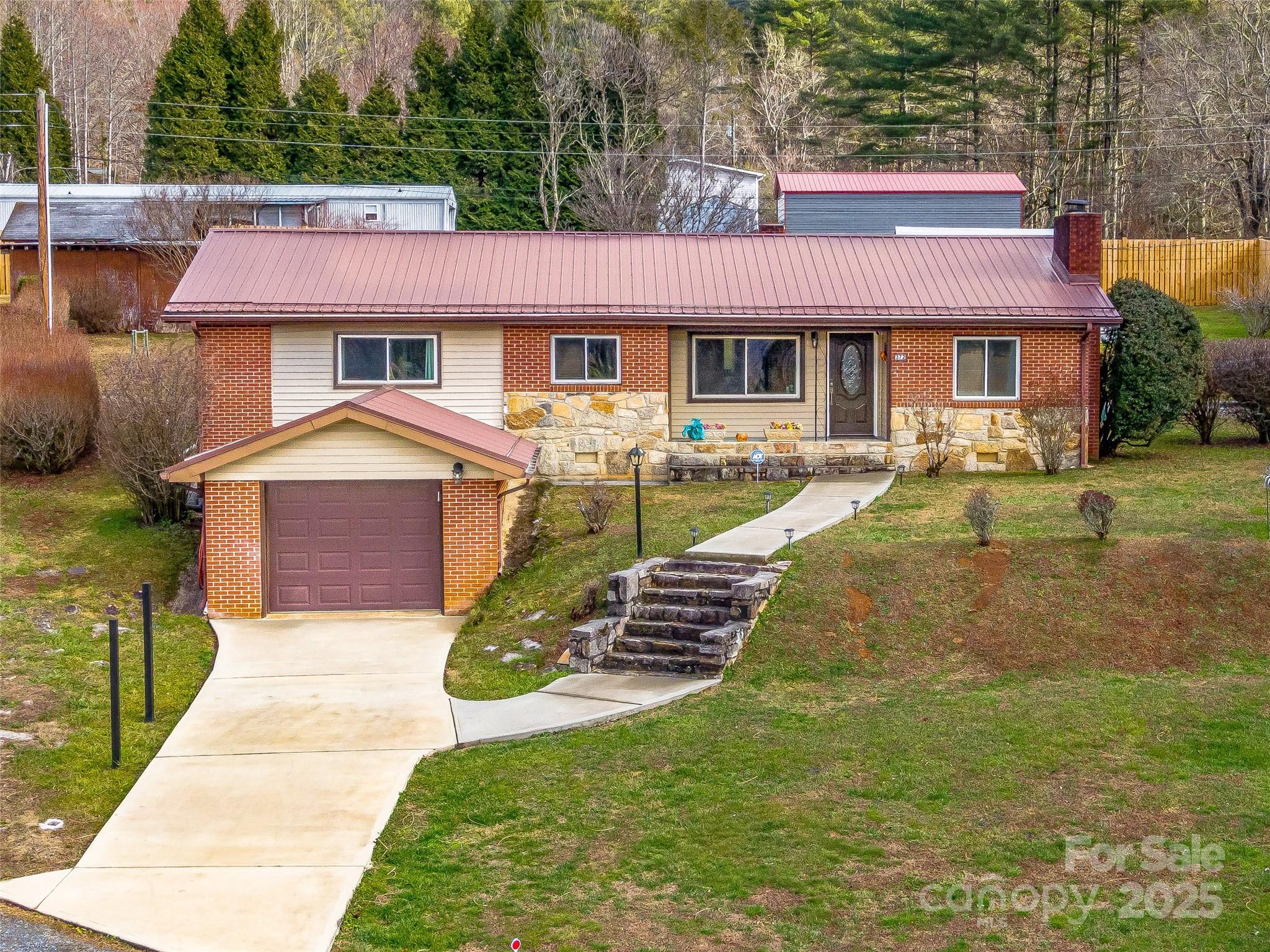 372 Hamilton Road Penrose, NC 28766 - Photo 2 of 38 a front view of a house with a yard table and chairs