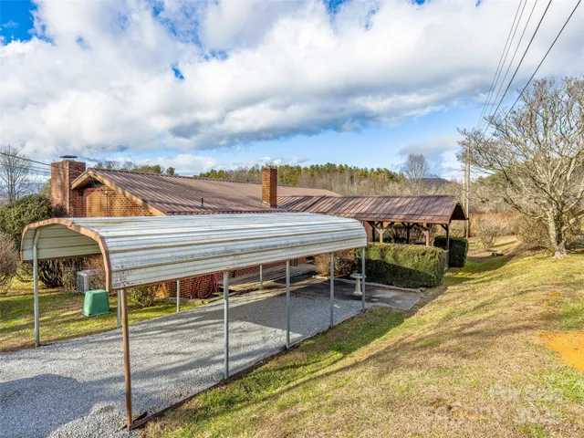 a view of a house with a balcony and wooden fence