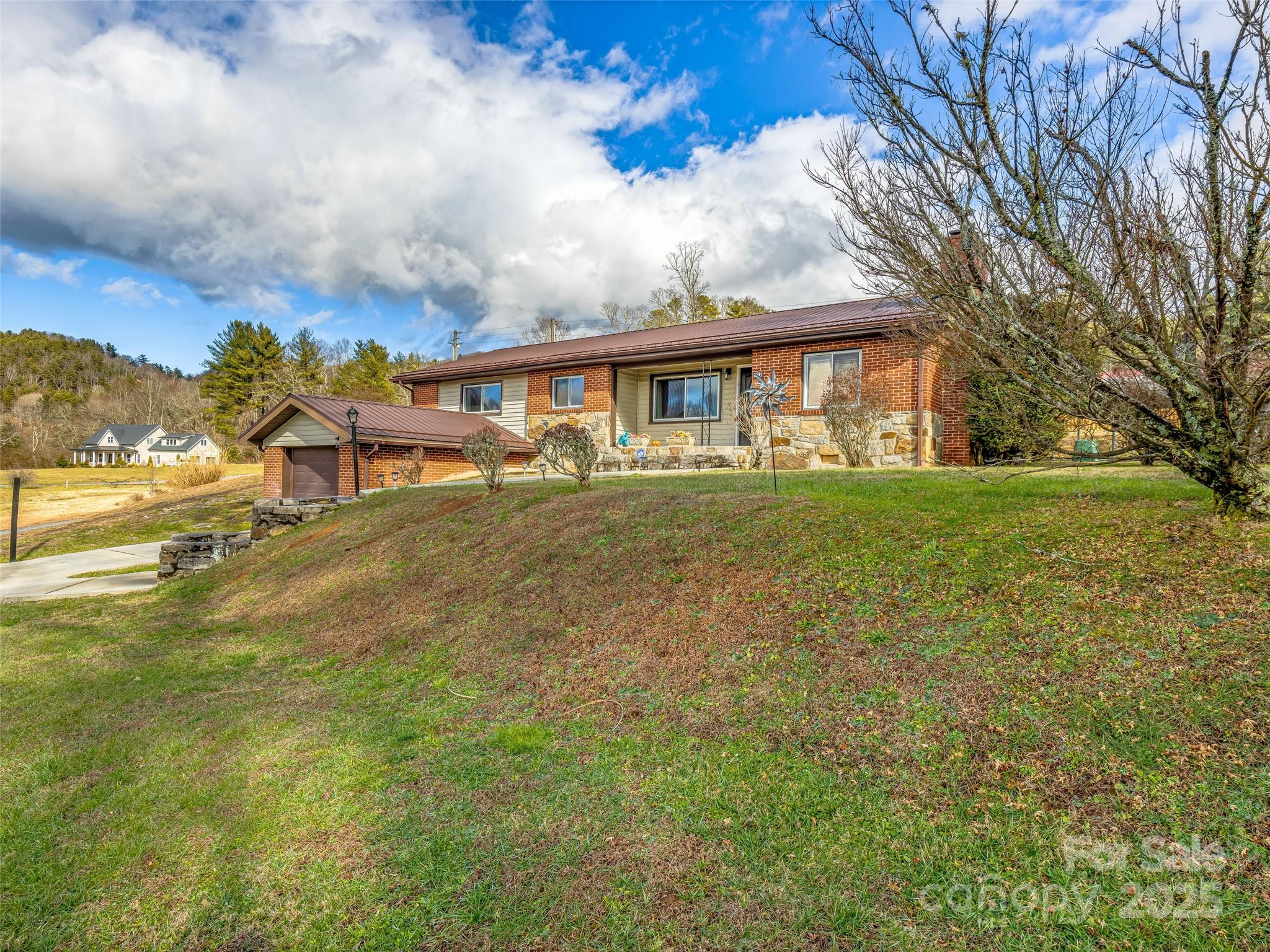 372 Hamilton Road Penrose, NC 28766 - Photo 3 of 38 a view of a house with a big yard and large trees