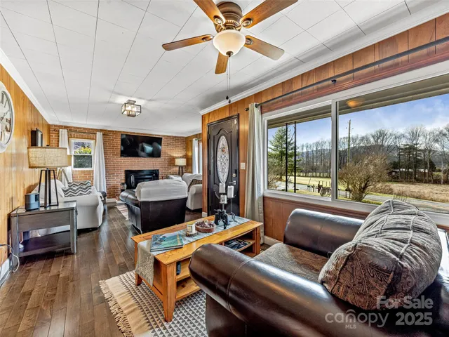 a living room with furniture and a floor to ceiling window