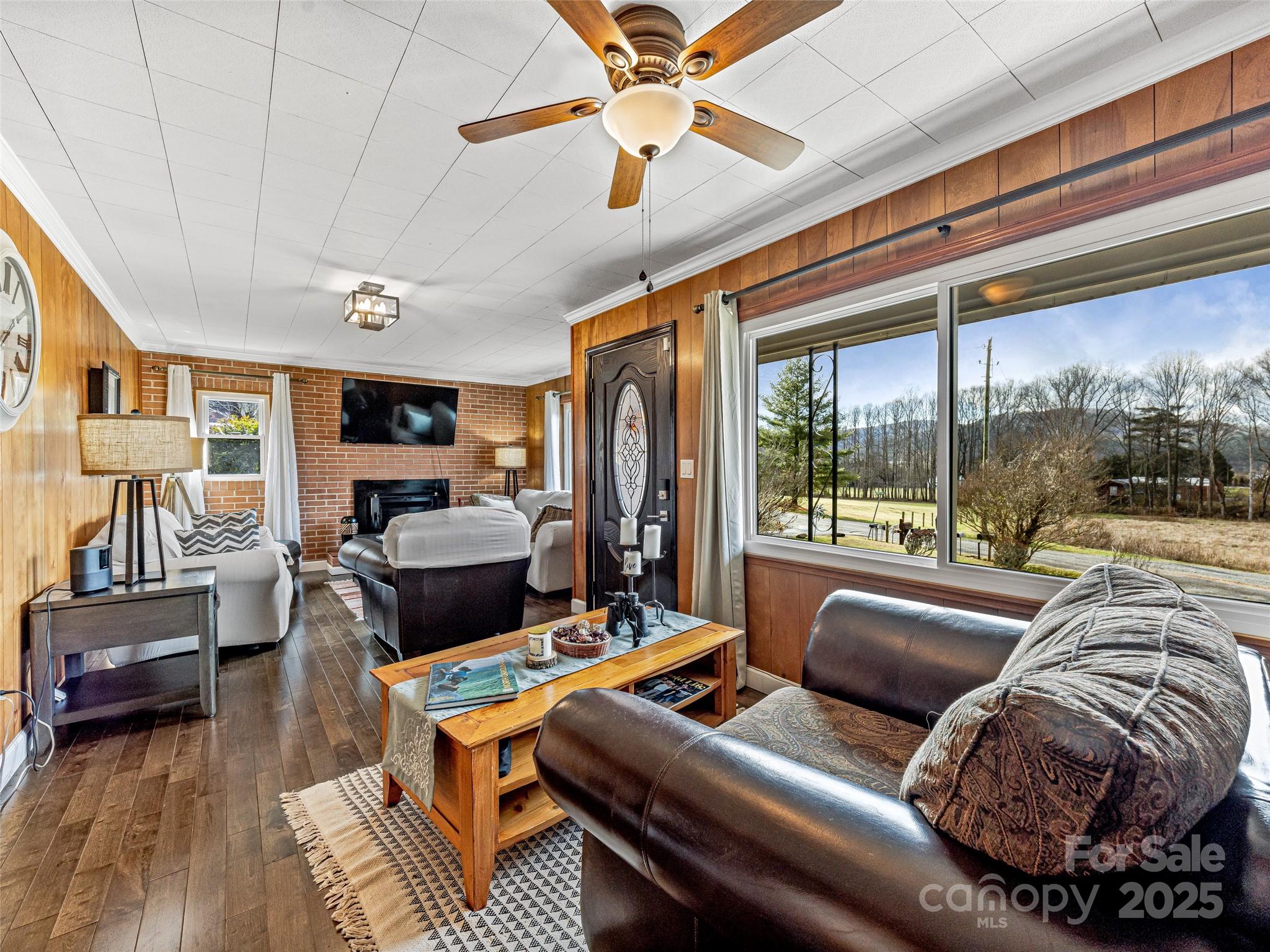 372 Hamilton Road Penrose, NC 28766 - Photo 9 of 38 a living room with furniture and a floor to ceiling window