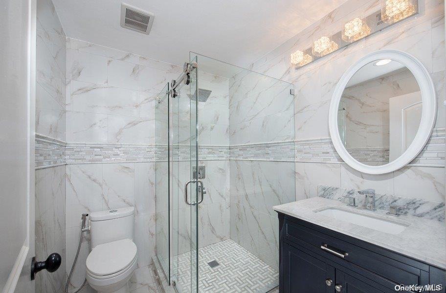 9 Tower Hill Road Shoreham, NY 11786 - Photo 11 of 41 Full bath, first floor off SItting room - single sink vanity with stall shower, glass entry