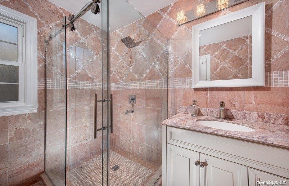 9 Tower Hill Road Shoreham, NY 11786 - Photo 13 of 41 En Suite with single sink vanity, stal shower with glass door entry