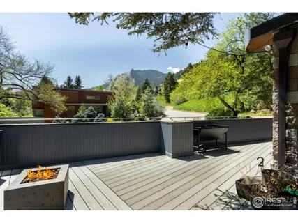a view of balcony with wooden floor and a garden