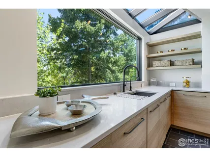 a kitchen with a sink and a large window
