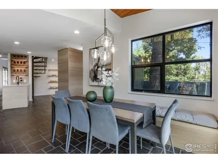 a view of a dining room with furniture a chandelier and wooden floor