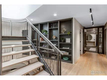 a view of staircase with lots of frames and frames on wall