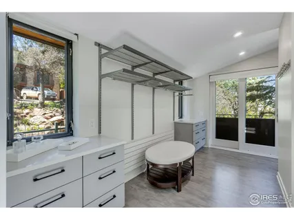 a living room with furniture a window and a flat screen tv