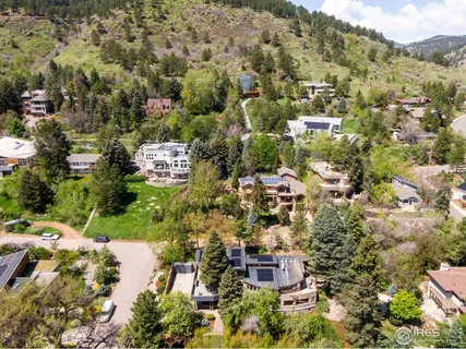 a view of a houses with a lush green hillside