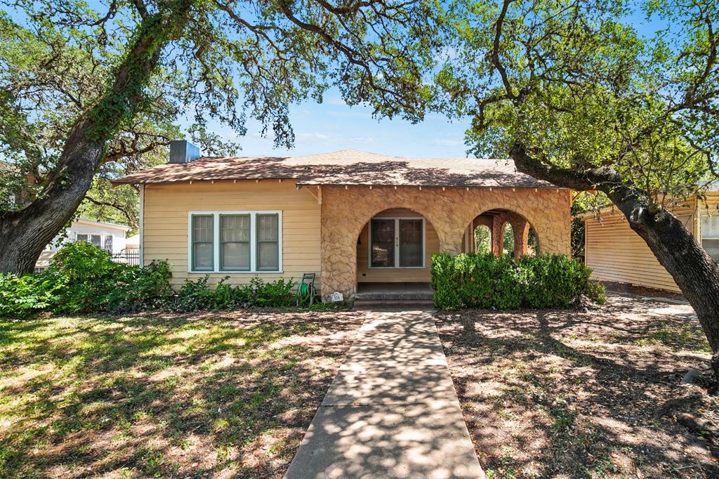 514 South Main Street Lockhart, TX 78644 - Photo 1 of 14 a front view of a house with a garden