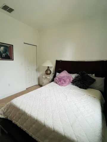 a bedroom with a bed and lamp