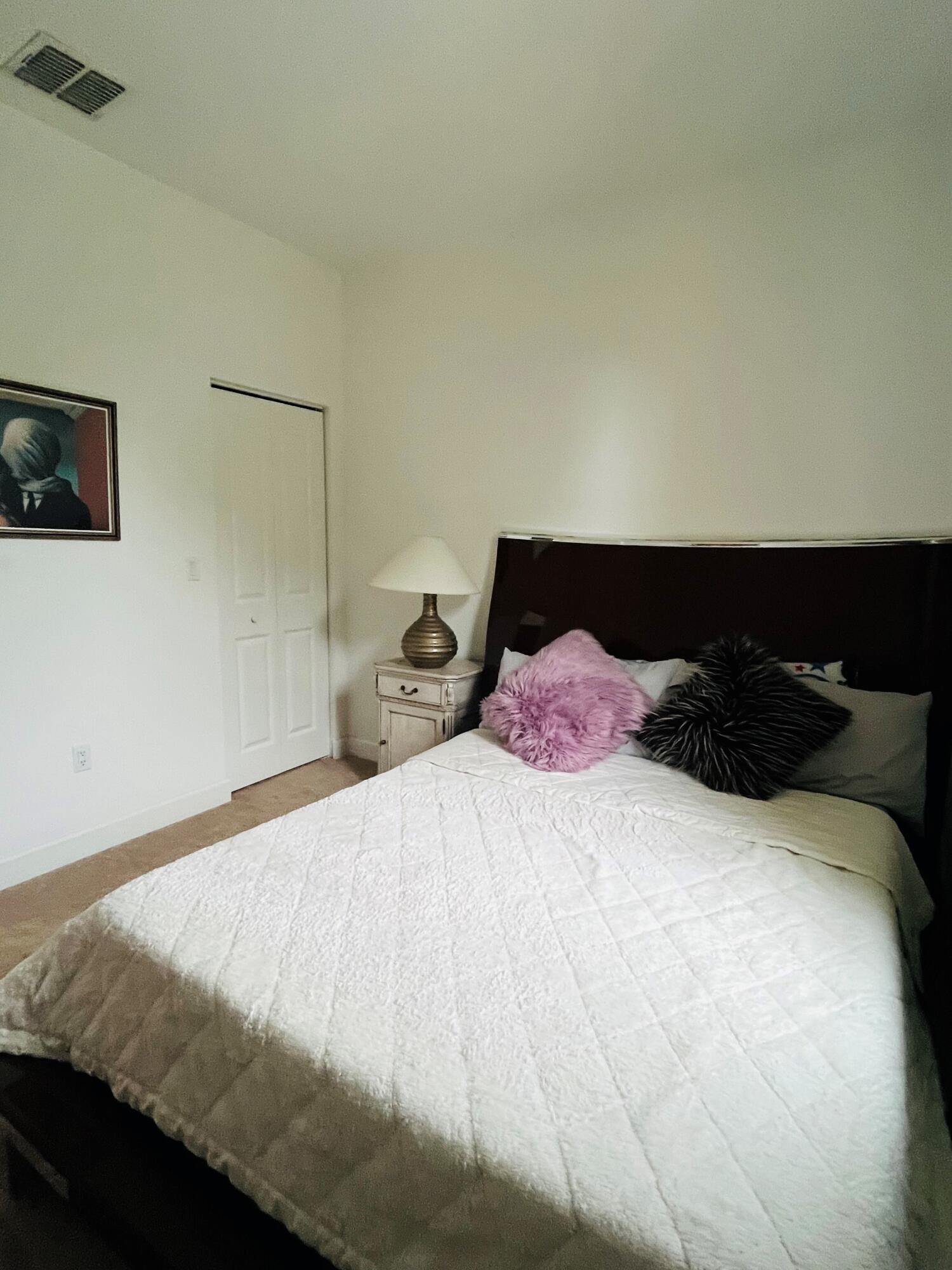 5211 Northwest 50th Terrace Tamarac, FL 33319 - Photo 11 of 15 a bedroom with a bed and lamp