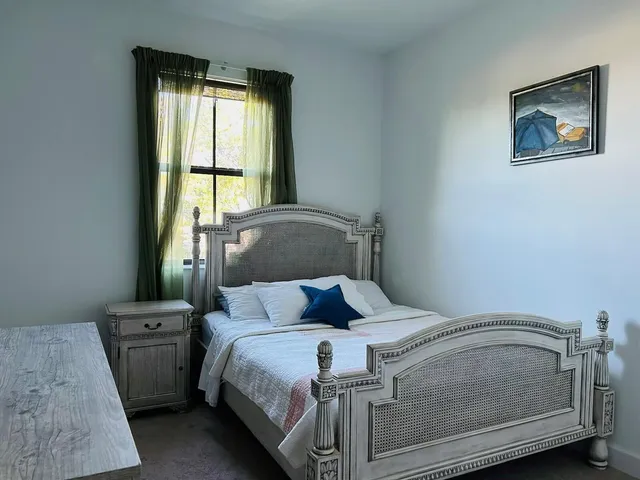 a bedroom with a bed and a window