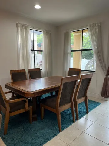 a view of a dining room with furniture and window