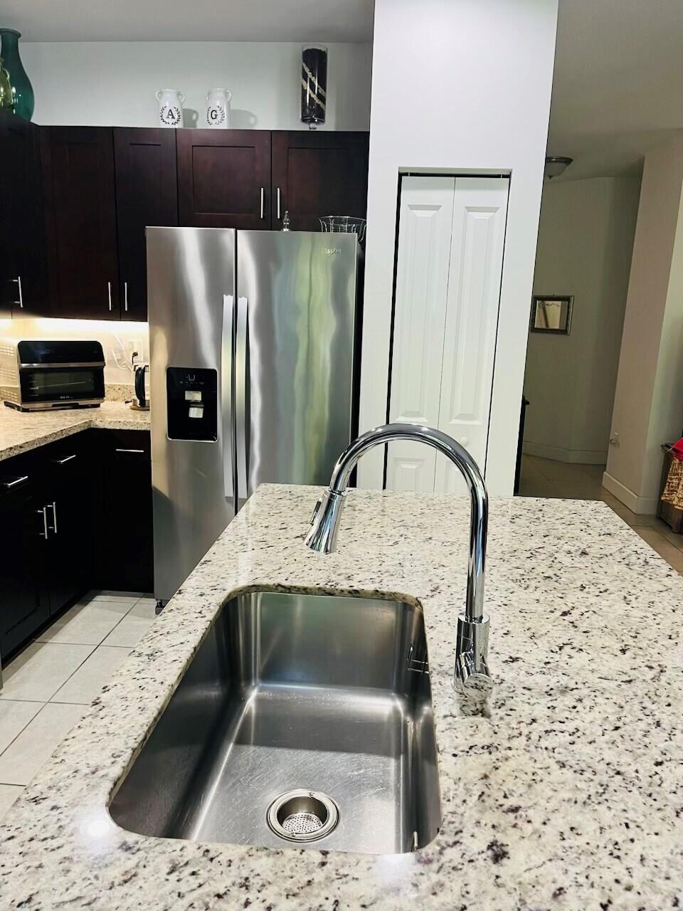 5211 Northwest 50th Terrace Tamarac, FL 33319 - Photo 9 of 15 a kitchen with a sink and a refrigerator