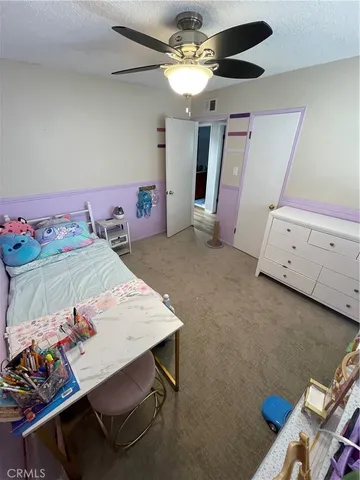 a view of a dining room with furniture and a chandelier fan
