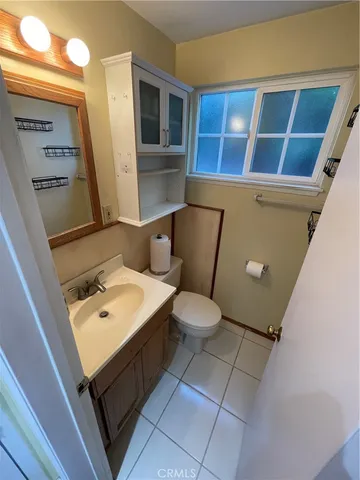 a bathroom with a sink a toilet and mirror