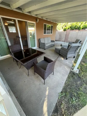 a living room with furniture and large windows