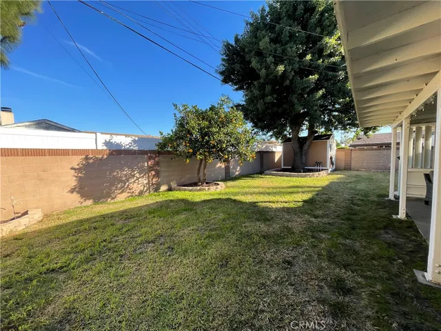 a view of a backyard with plants and a patio