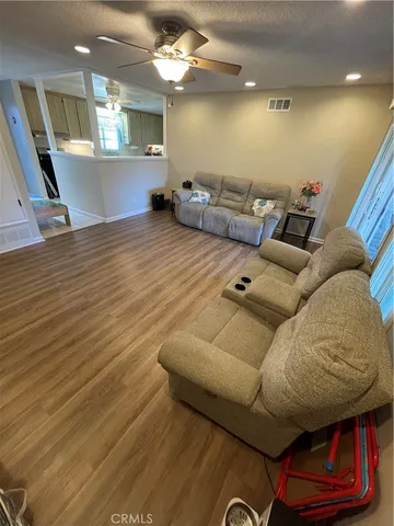 a living room with furniture and wooden floor