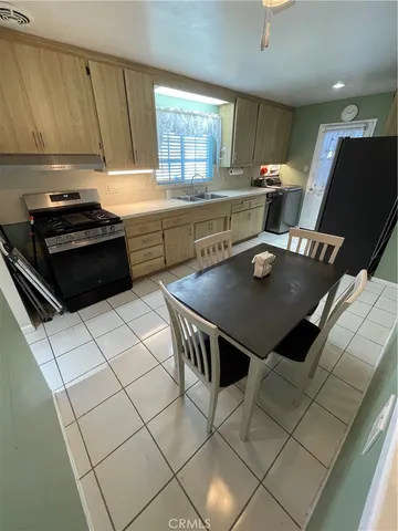 a kitchen with a table chairs and a stove