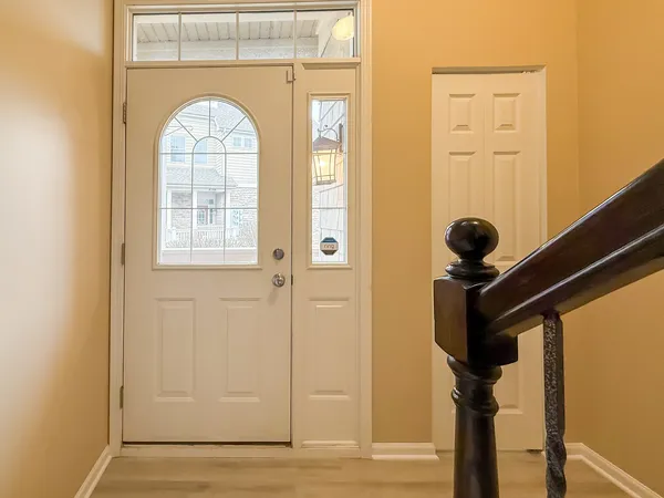 a view of an entryway with wooden floor and stairs