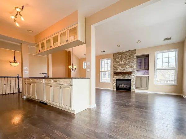 a large kitchen with stainless steel appliances granite countertop a stove a sink and a microwave
