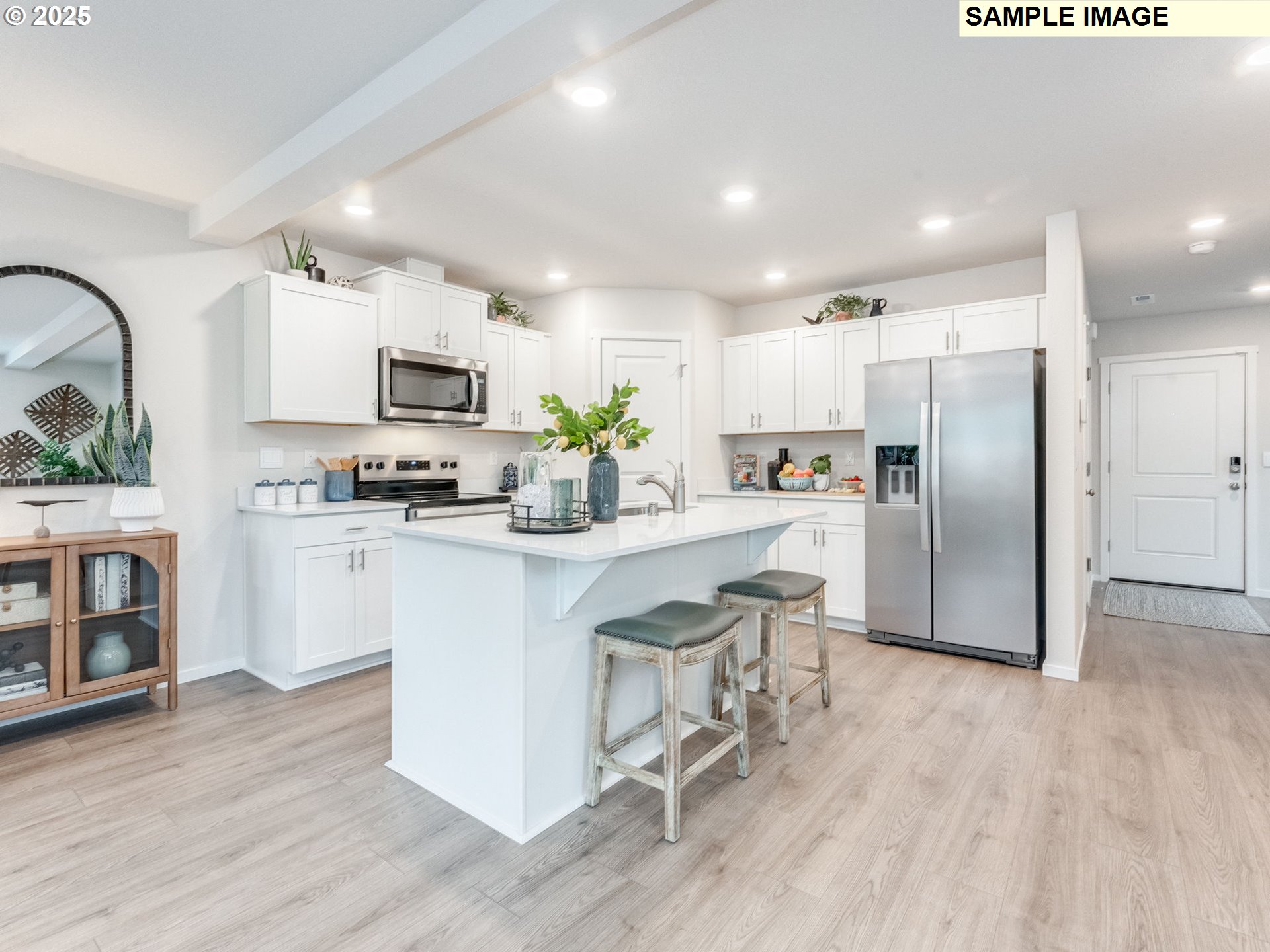1103 Southeast 194th Place Camas, WA 98607 - Photo 4 of 23 a kitchen with kitchen island a refrigerator a stove a microwave oven a sink with island and chairs