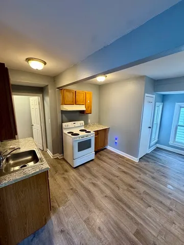 a kitchen with granite countertop a stove and a refrigerator