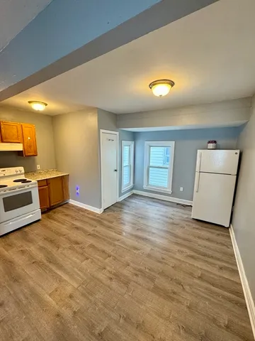 a view of a kitchen with a sink and a refrigerator