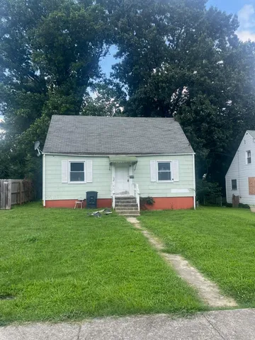 a aerial view of a house next to a yard with green space
