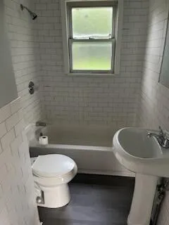 a bathroom with a toilet a sink and bathtub